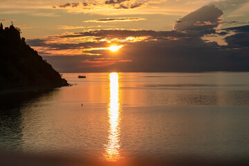 Romantic sunset painting the horizon from charming coastal village of Fiesa, Slovenia, Europe....