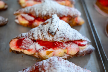 French cuisine, fresh baked strawberry croissants with cream and fresh fruits