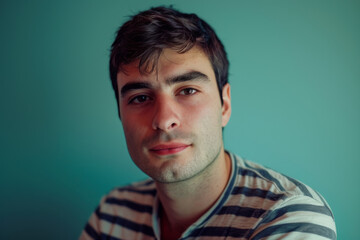 Fototapeta premium A man in a striped shirt looks at the camera