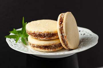 Three delicious alfajores filled with dulce de leche, sprinkled with grated coconut...