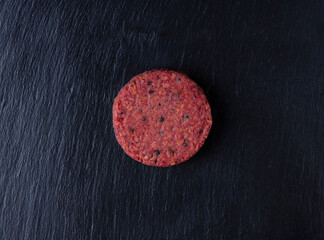 Raw burger with truffle on a black stone background...
