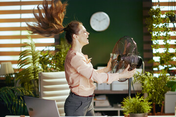smiling modern business woman in modern green office