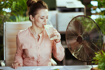 modern woman employee at work with electric fan
