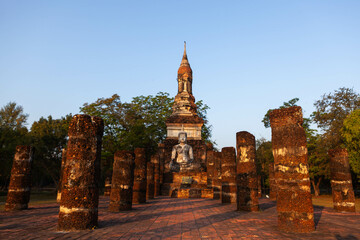 Sitting Buddha statue in front of Wat Mahathat. Old buddhist temple. Sukhothai Historical Park....