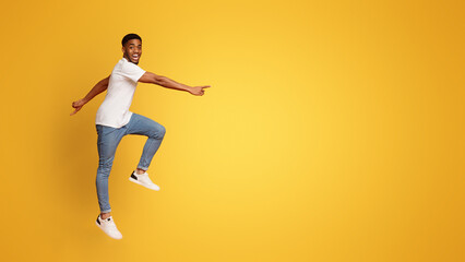 Excited african american guy walking in air