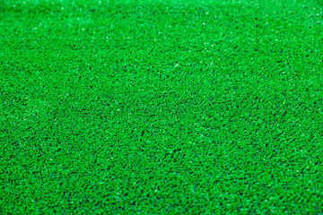 Vibrant green artificial grass texture close-up