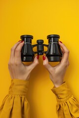 Fototapeta premium A person holding a pair of binoculars, suitable for various concepts and themes