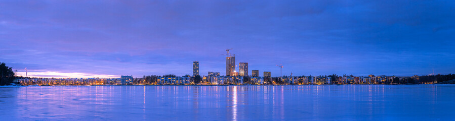 Fototapeta premium Winter Panorama of Helsinki's Vuosaari district in Finland. Panorama of a winter evening in Helsinki.