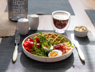 English breakfast. Boiled egg, jamon, waffles and green herbs. - 779142110