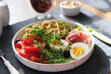 English breakfast. Boiled egg, jamon, waffles and green herbs. - 779142129