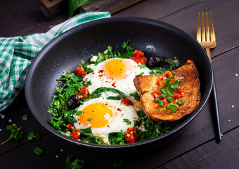 Keto breakfast. Fried eggs  with spinach and toast. - 779142708
