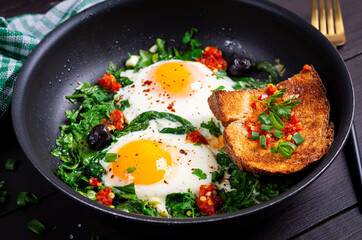 Keto breakfast. Fried eggs  with spinach and toast. - 779142724