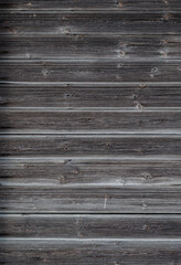 Texture of dark gray wooden wall of old weathered boards