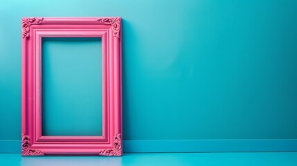 Pink empty frame on vibrant blue background creates a striking contrast between vintage and...