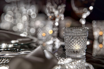 Table setting in a restaurant, crystal corrugated glasses with napkins at a banquet.