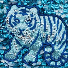 A digital artwork of a tiger cub constructed from a mosaic of beads and sequins