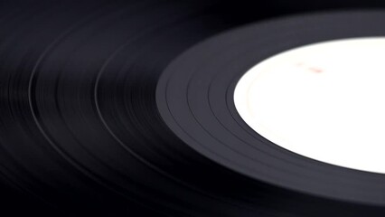 Closeup of a spinning vinyl record. Music playing. Vintage audio nostalgia.