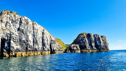 A narrow path to the floral carpet of the Firth of Forth between the spectacular rocky cliffs on...