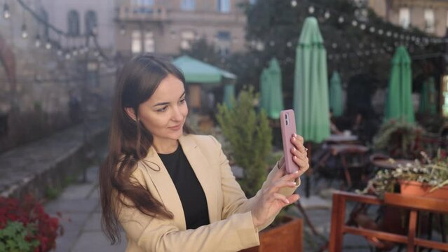 Successful female, Career selfie, Corporate woman. Successful woman captures own image using smartphone.