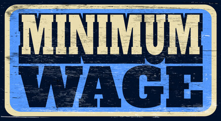 Aged and worn minimum wage sign on wood