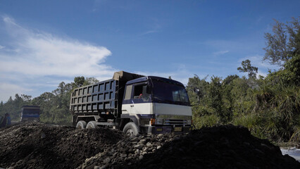 Trucks carrying road construction materials