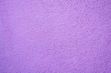 Purple colored cement wall texture background.