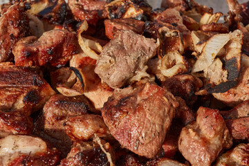 Barbecue from skewers removed in a glass form. Close-up.