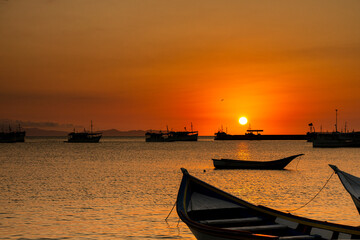 Fishing boats during a beautiful and colorful sunset in Juan Griego beach, Margarita Island....