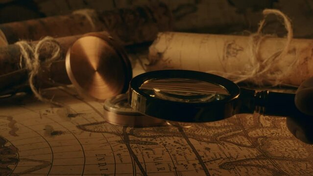 Compass and magnifier on a old vintage world map with countries and continents. Retro style. Concept of geography or global history and cartography. Wars of conquest and navigation. 4K ProRes