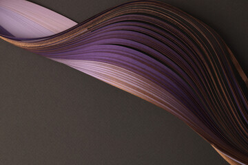 Gold, bronze, violet  Color strip gradient wave paper on black. Abstract texture background.