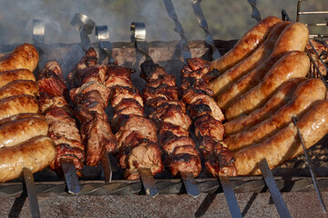 Meat is fried over hot coals in the grill. A barbecue will be cooked on the coals. Close-up.