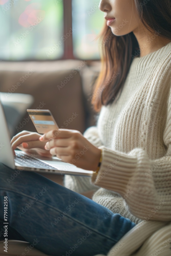 Poster a woman sitting on a couch using a laptop computer. suitable for technology and lifestyle concepts
