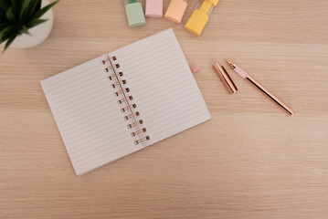 beige wooden table with notebook and pen to take notes colored marker pens - obrazy, fototapety, plakaty