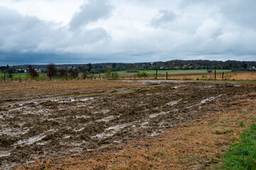 Dirty brown farmland in the rain at the Flemish countryside around Tervuren, Belgium