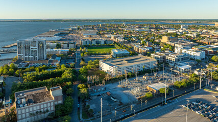  Golden sunrise light bathes downtown Charleston, South Carolina, with historic buildings and...