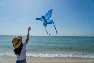 A Lovely Mature Brunette Model Enjoys Relaxing At The Beach While Flying Her Kite