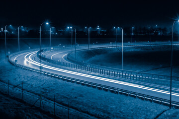 sharp bend of the road, long exposure of car lights at night