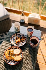 Summer family breakfast on the terrace, tea, cookies, snack. On a sunny morning