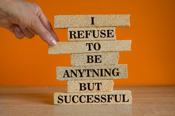I refuse to be anything but successful. Motivational quote to create future. Words on the brick blocks on beautiful orange background.