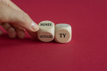 Honesty and integrity symbol. Businessman turns a wooden cube and changes the word integrity to...