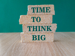 Time to think big symbol. Concept words Time to think big on brick blocks. Beautiful wooden table, green background. Business and time to think big concept.