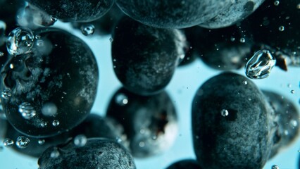 Macro shot of blueberries in the water.