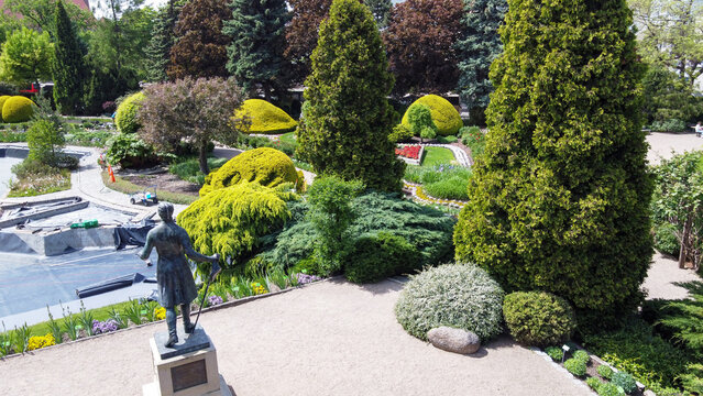 Amazing  drone point of   view on Wroclaw Botanical garden with flowerbeds and garden pathes: awe flowerbeds and topiary trees