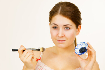 Woman being apply black carbo mask to face