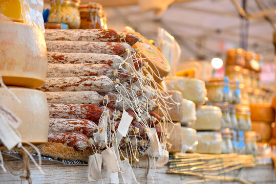 Market stall of farmer's market with cheeses, sausages and vergine olive oil