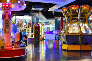 Play fun area for gamer with various bright colorful attractions and slot machines