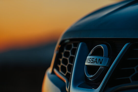 Nissan Qashqai car emblem close-up at sunset