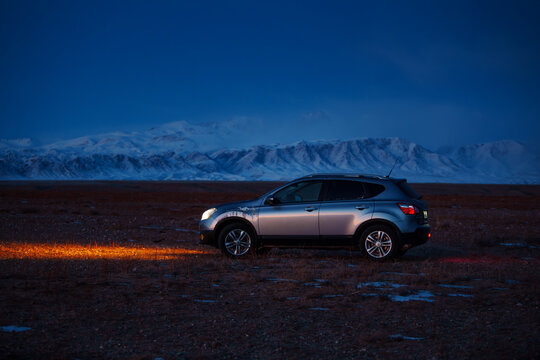 Nissan Qashqai car on mountain background at night time