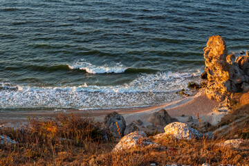 Seascape. Rocky seashore with a foamy wave, view from the mountain. Travel and tourism