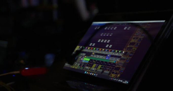The monitor of the control panel of the lighting director at the concert performance of a popular artist. The dark room of the theater in which the monitor of the lighting engineer. High quality 4k